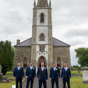 groom and groomsmen and church
