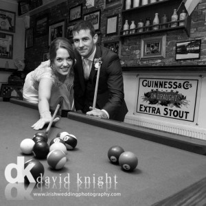 Bride and groom playing pool