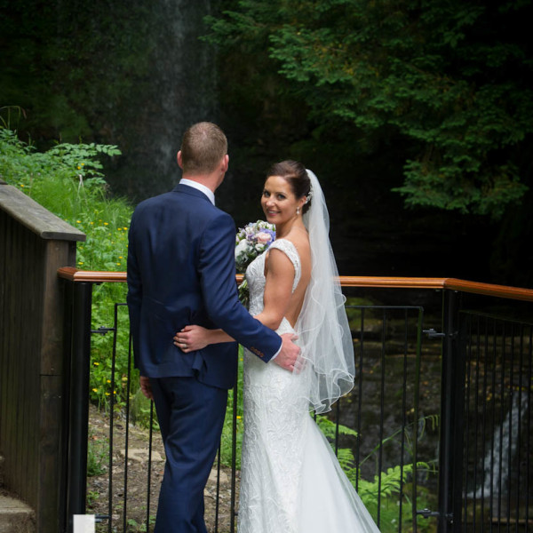 bride and groom at Glencar Waterfall